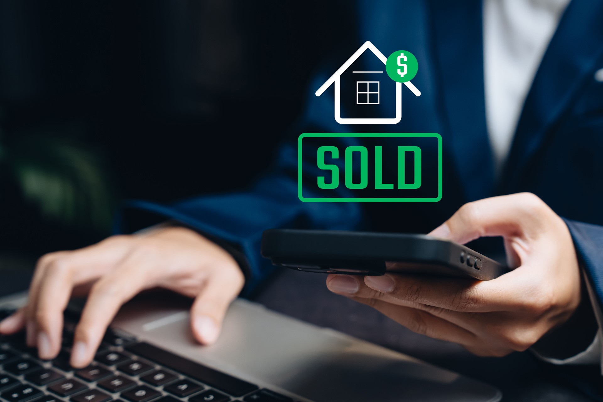 Online property sales concept. Man holding smartphone with virtual house icon and sold label representing successful deal.